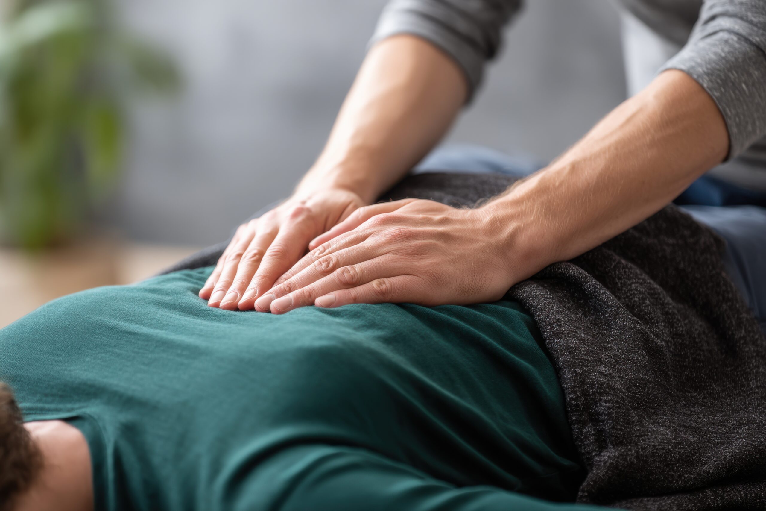 close up of therapist's hands applying reiki healing touch to a patient's body, focusing on relaxation and well being through energy therapy and alternative medicine practices.